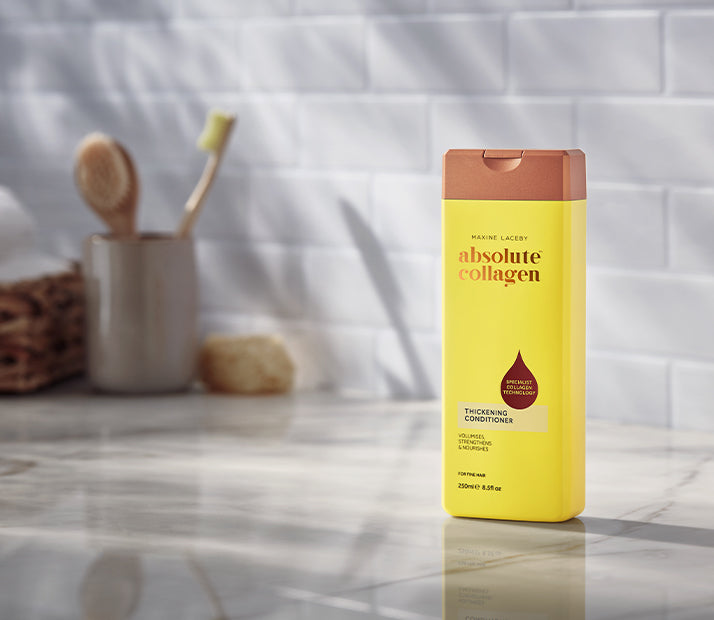 Image of single bottle of Absolute Collagen Thickening Conditioner on a bathroom counter.