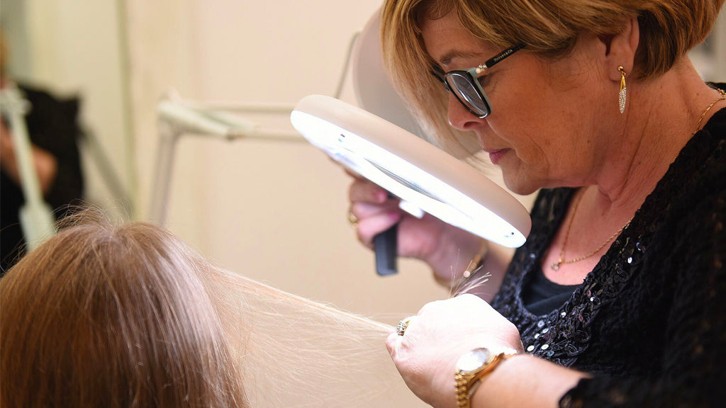 Header image of Eva examining patients hair